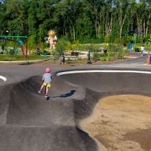 Kid scootering on pump track
