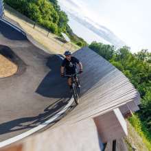 person riding wodden wall at pump track
