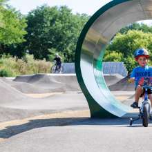 Child riding through tunnel