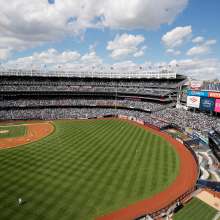 Angled view of Yankees Stadium with a clouded blue sky
