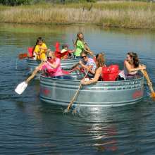 A group of tourists goes tanking along a river
