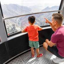 dad and son on tramway car