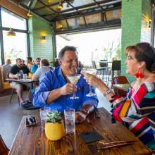 Couple toasting at 1501 Gastropub.