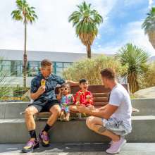 Gay family eating ice cream outdoors in Palm Springs.