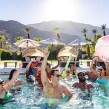 Group of triends partying in pool.