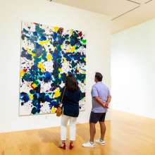 A couple looking at a painting at the Palm Springs Art Museum
