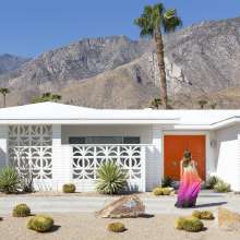 Women in front of midcentury house.