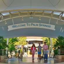 Three people walking to gate at PSP.