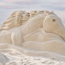 Large horse sculpture made of sand.
