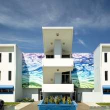 Photo of Public Artwork, colorful wave mural on the front of the Amman Building.