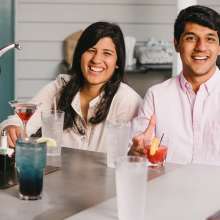 A woman and a man sitting at a table smiling