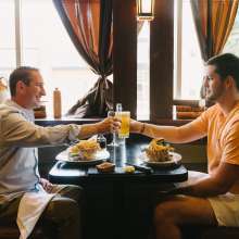 Two people sitting at a table having a meal
