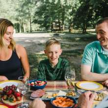 A family sitting together at a picnic table