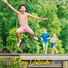 Young boys jumping off a pier into a lake