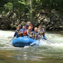 a group of people is white water rafting