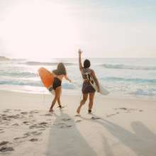 Surfers walking on beach