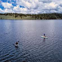 two paddle boarders on a lake
