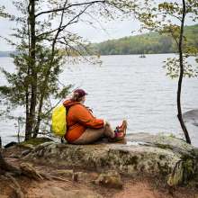 a hiker at Gifford Pinchot State Park enjoying the view of the lake