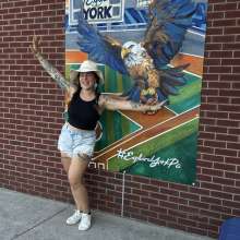 Annelise Vuono posing with her handpainted mural inside WellSpan Park
