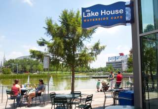 Lake House Restaurant outdoor seating on a sunny day with people enjoying the lake view