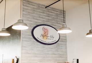 Image of sign surrounded by lights at Mystique Edge Salon & Spa in Downtown Rapid City, SD