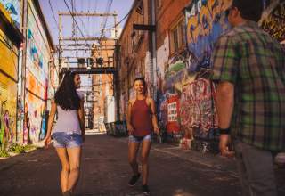 people walking through art alley in downtown rapid city, sd