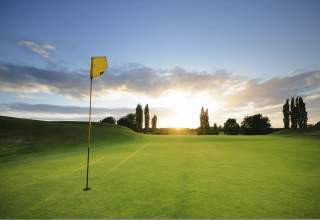 Golf course flag with sunset in the background at Red Rocks Golf Course in Rapid City, SD