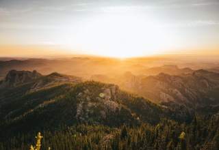 Sunset over Black Hills National Forest creating a golden hue over the land