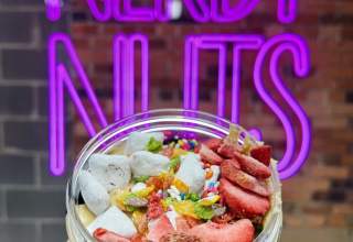 Person holding a jar of peanut butter with toppings at the Nerdy Nuts experience in Rapid City, SD.