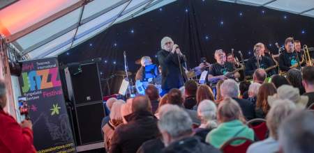 Sir Karl Jenkins singing on stage at Swansea Jazz Festival