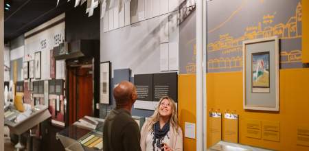 Couple exploring the Dylan Thomas Centre exhibition in the dylan thomas centre