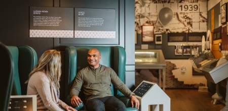Couple exploring interactive exhibits in the dylan thomas exhibition