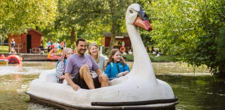 Family riding a swan pedalo in singleton park