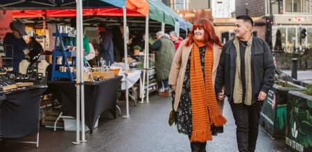 A couple walking through Uplands Market