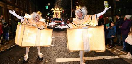 dancers dressed as light up christmas presents on rollerskates in the swansea christmas parade