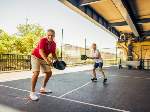 Couple playing pickleball at RiverWalk Commons