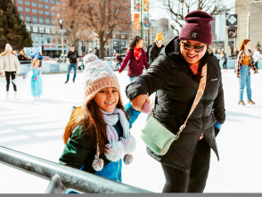 Mom and daughter holding hands while ice skating
