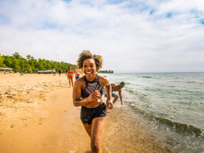 girl running on the beach with her friends following behind