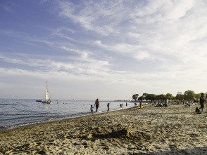 wide view of Bradford Beach, boats and people in the water