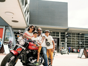 family of four on and around a Harley Davidson Motorcyle
