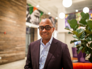 Greg Wesley stands in a modern lobby