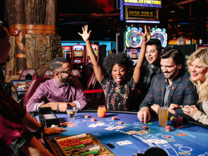 players gathered around table game while one cheers