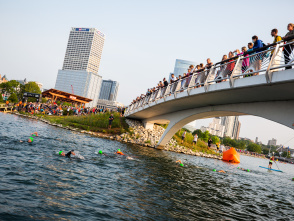 wide shot of USA Triathlon atheletes jumping into the lagoon next to Discovery World