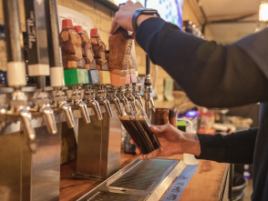 Bartender pouring a pint of beer at Wizard Works Brewing