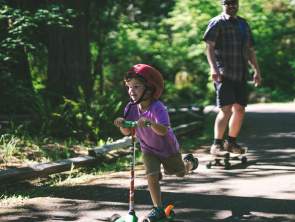 A kid riding a scooter