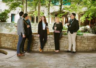 Group of meeting professionals gathering in front of grotto at Henry B.Gonzalez Convention Center