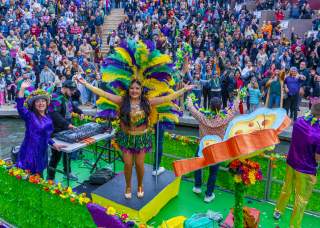 Woman on parade float at San Antonio River Walk Mardi Gras River Parade
