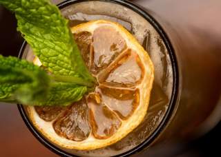 Adult beverage with greenery as garnish