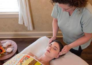 Masseuse rubbing woman's head
