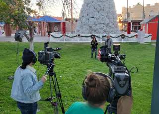 Video production crew in front of Chandler Tumbleweed Tree